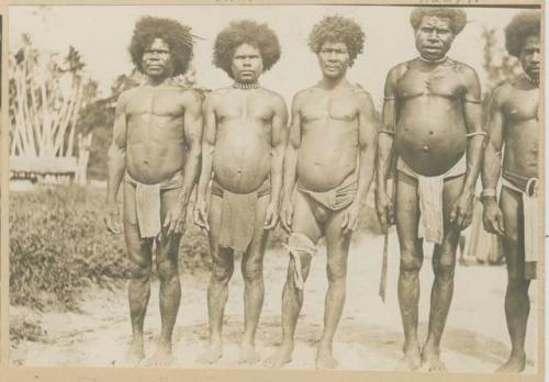 Men standing in a row outside