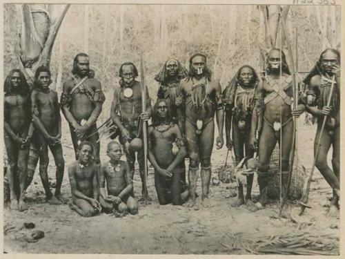 Group of men outside with spears and weapons