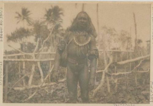 Man standing outside in front of fence