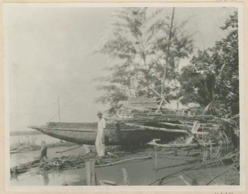 Westerner in front of outrigger canoe