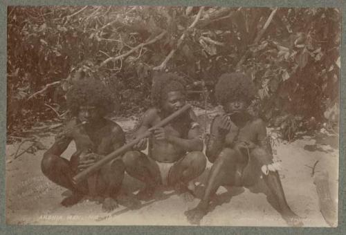 Three Aronia men sitting outside holding objects to mouths, possibly instruments