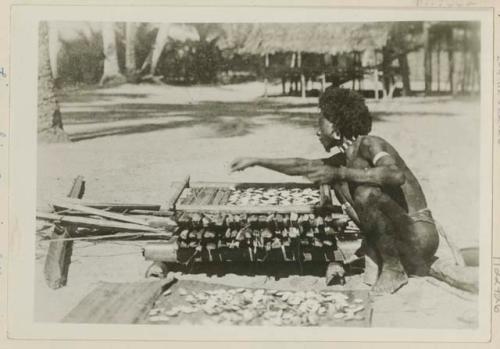 Man arranging shells in a kiln to make lime