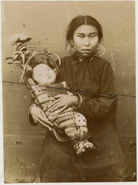 Woman with baby in cradle