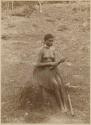 Woman sitting on rock