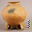 Large round pottery jar with tripod looped leg base