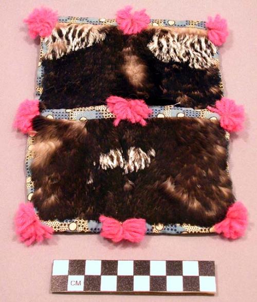 Small loon skin pouch trimmed with calico and wool balls