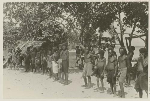 Group of people standing under trees