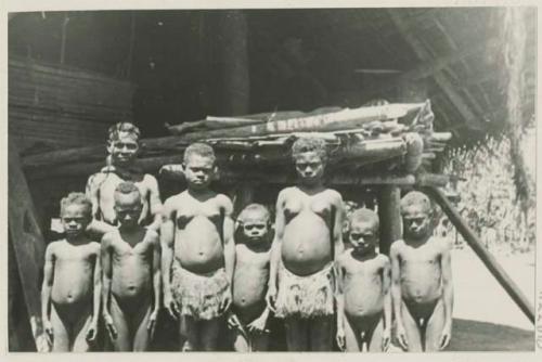 Group of children in front of a structure