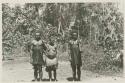 Two men and a woman, including photographer's guide holding a rifle.