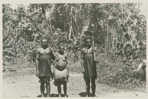 Two men and a woman, including photographer's guide holding a rifle.