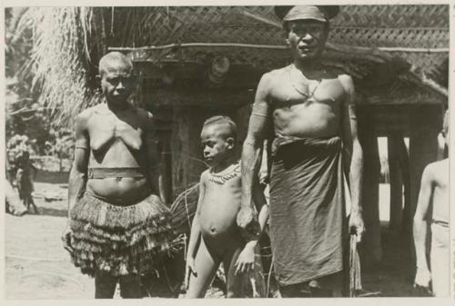 Goverment representative, with wife and children in front of house