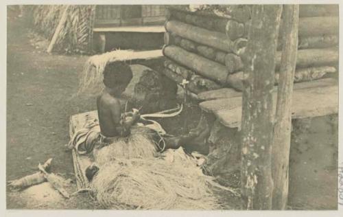 Woman working next to building