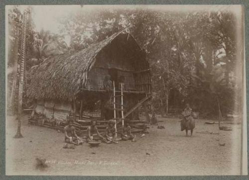 People sitting in front of house