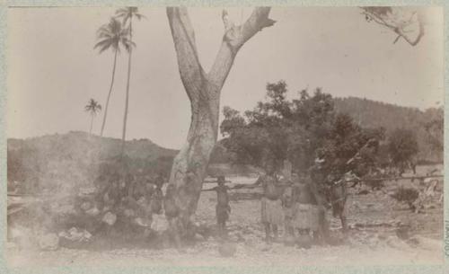 Group of people standing under a tree