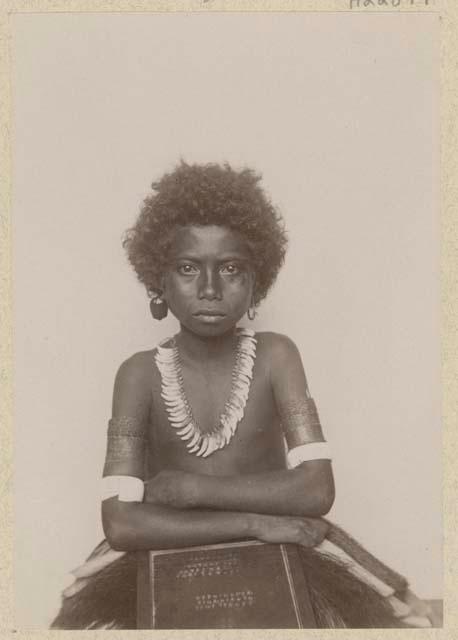 Studio portrait of girl holding a board with writing on it