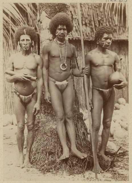 Three men standing in front of a tree