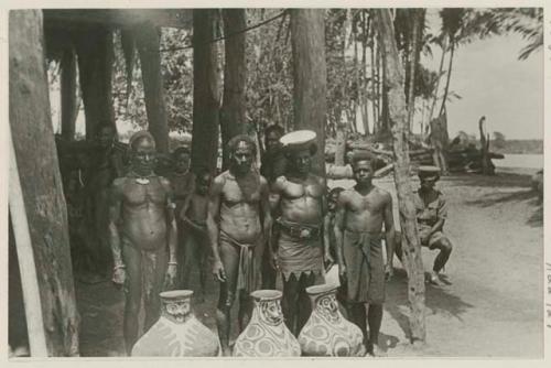 Group of men and large decorated ceramic vessels