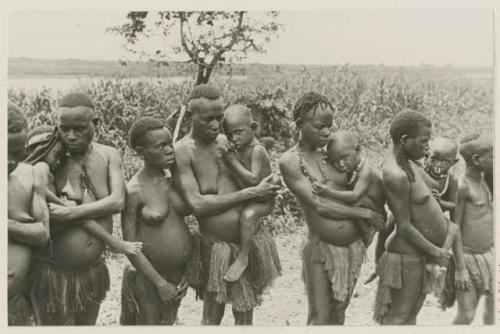 Women holding children, some nursing