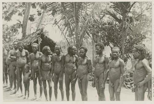 Men and child standing in a line