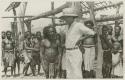 Group of men and child standing under wooden structure