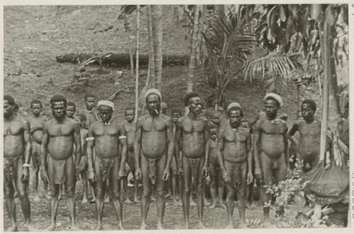 Group of men in front of trees