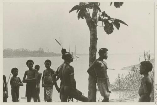 Group of people, administrator's yacht in background