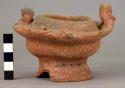 Unpainted pottery bowl - ring base, figures in relief on flaring shoulder