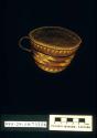 Twined teacup-shaped basket, with handle: geometrical motifs