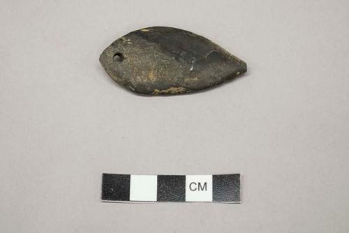 Archaeological, ground stone pendant with single hole