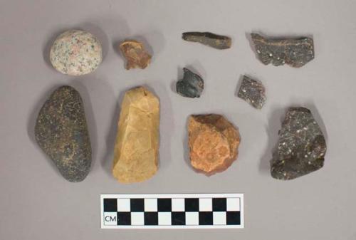 Chipped and ground stone including flakes, blades, cores, and possible hammer stones