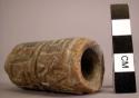 Clay tube with heavily incised decoration