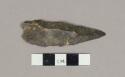 Flint pointed blade: with partial retouch on one side near the point & use (?) o