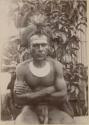 Man wearing headdress, earrings, necklace