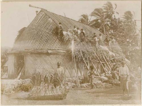 People building roof