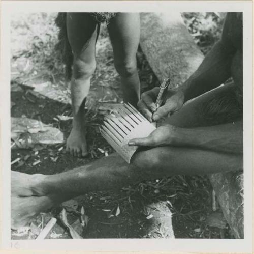 Man carving bamboo comb