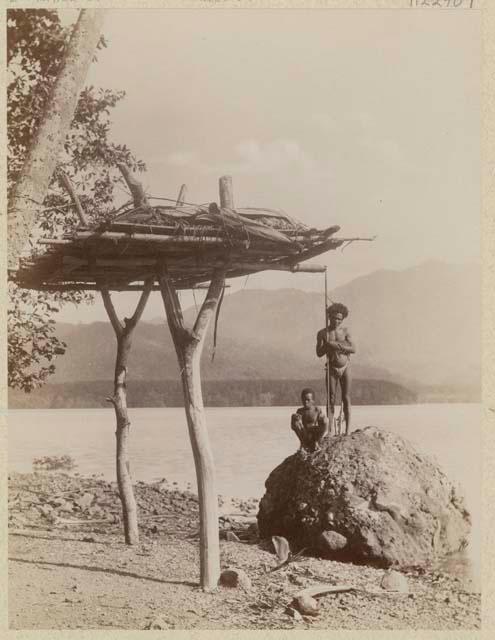 Men beside platform for corpses