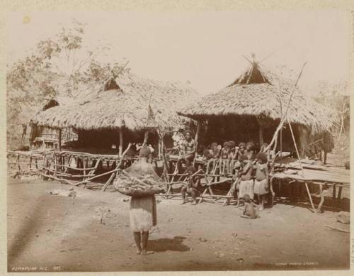 Children on porch and woman with bag