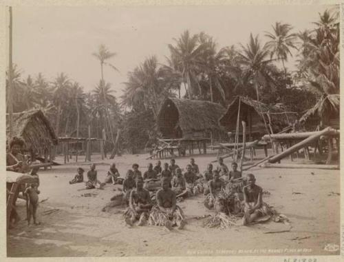 Women in market place, buildings on stilts with thatched roofs