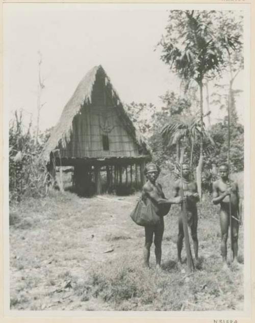 Men in front of house