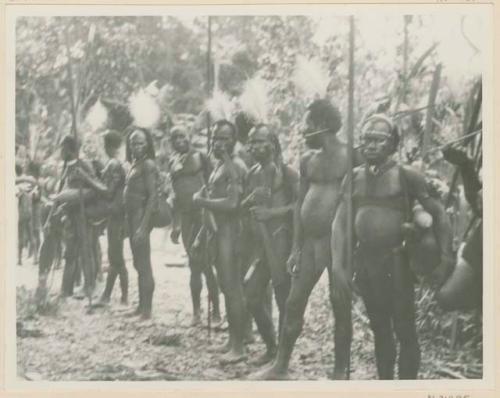 Men with egret plume headdresses