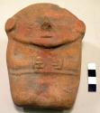 Pottery figurine of man- large head, no form; hands clasped across chest