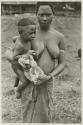 Women holding child and monkey