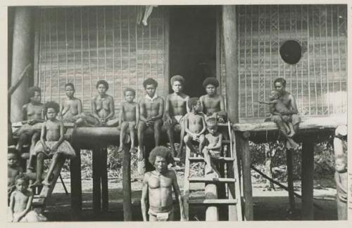 People on porch of building on stilts