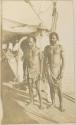 Three men, one Western, on dock or boat