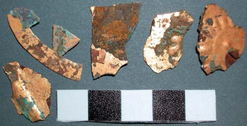 Metal ornament fragments, flat, impressed design, gold and copper.