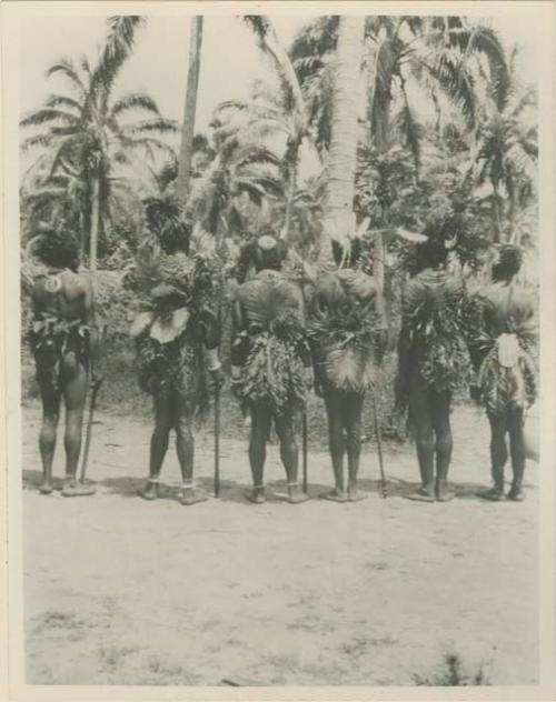 Chiefs standing with back towards camera