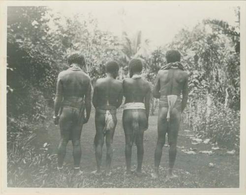 Two men and two women showing back of waistband arrangements