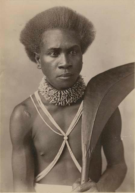 Studio portrait of man with porpoise tooth necklace