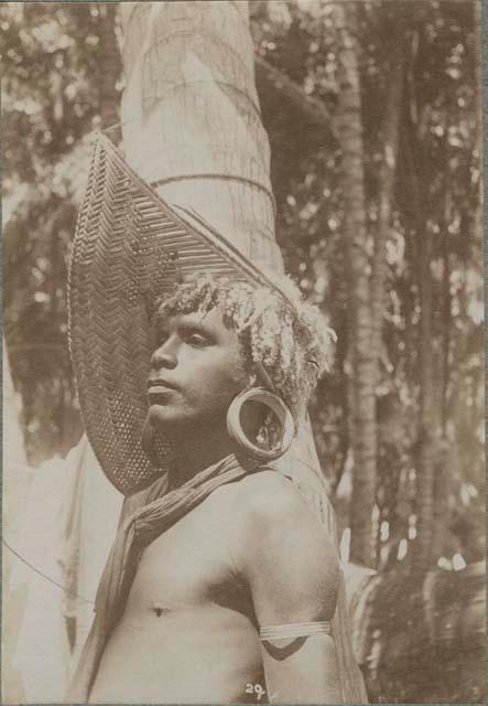 Man with ear plug and woven visor