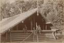 Three people in front of house